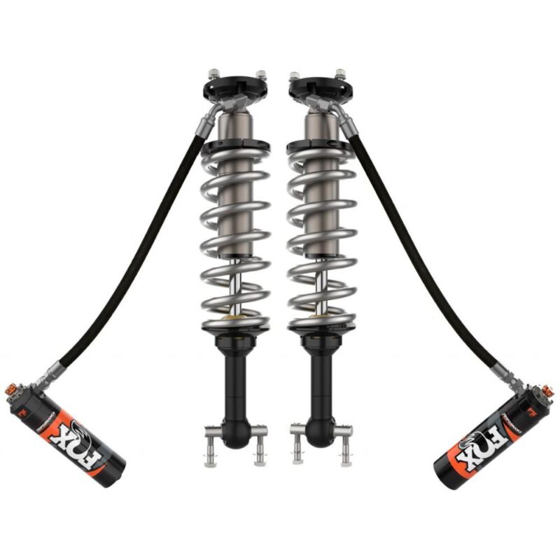 A presentation photo of the product "Front Adjustable Shock FOX Performance Elite Series 2.5". The photo showcases the pair of shocks with silver bodies, external reservoirs, and springs.
