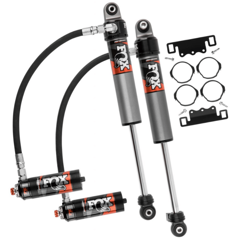 Package contents of Front FOX Shocks Performance Elite 2.5 Reservoir Adjustable DSC Lift 0-1,5″, showing the shock absorbers, hardware, and the universal mounting bracket.