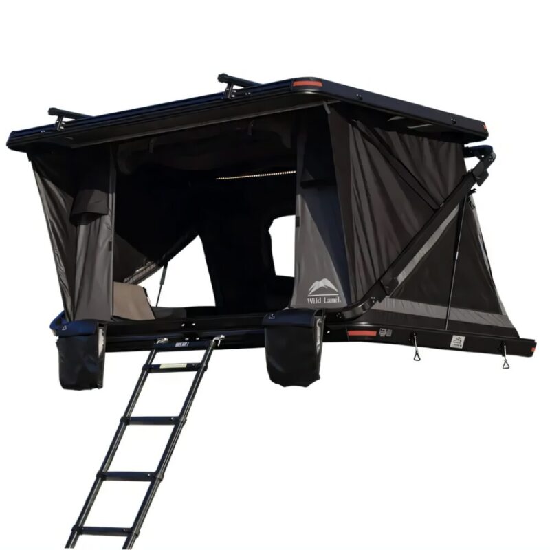 The Rock Cruiser rooftop tent for the car, with an open entrance and the ladder extended. The ladder is held with metal hooks in 2 slots in front of the entrance. On the left and right are the detachable "pockets" for shoes.