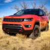 Front view of an orange Jeep Compass lifted 4cm.