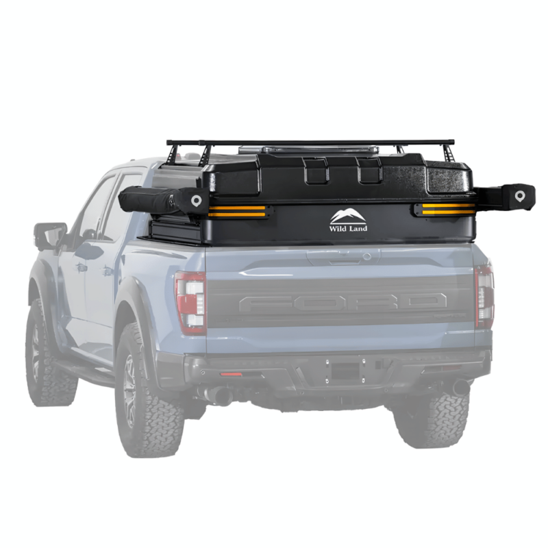 Rear view of a pickup truck driving with the Safari Cruiser car roof top tent folded down and closed in its hard shell. The closed shell is as tall as the cabin, and installed on the bed rail guards to keep cargo bed storage space unaffected.