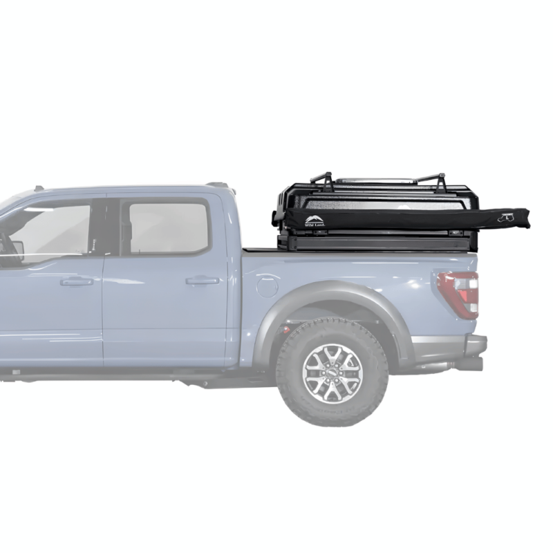 Side view of a blue pickup truck with a compactly packed Safari Cruiser car rooftop tent by WildLand mounted on the truck bed, highlighting its low-profile design when not in use.