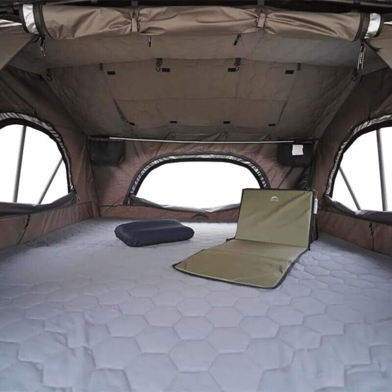 Interior of the Car Rooftop Tent 4-6 People Wild Cruiser 250 by WildLand. 3 large windows, skylight on the roof, internal pockets, and comfortable mattress.