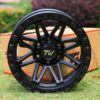 Front view of TW Wheels T23 Vector Full Black displayed on grass