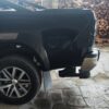 Image showing the Toyota Hilux 2015+ Retractable Rear Bumper Steel Step folded and installed on the rear bumper.