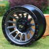 Front view of TW Wheels T22 Rotor Gunmetal displayed on grass